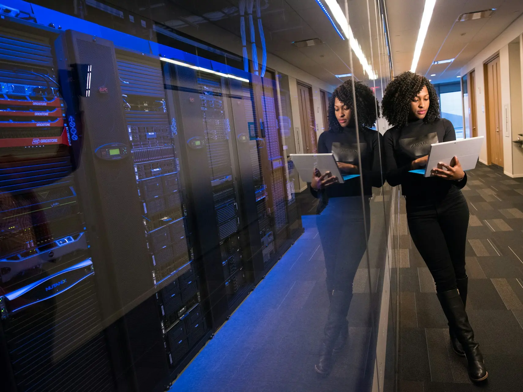 woman in black top using Surface laptop